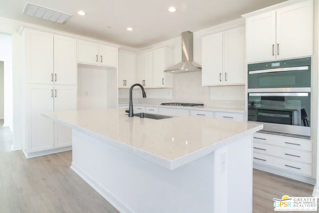 78924 Santa Rosa Way Palm Desert, CA 92211 - Photo 29 of 71 a kitchen with kitchen island a sink stainless steel appliances and cabinets
