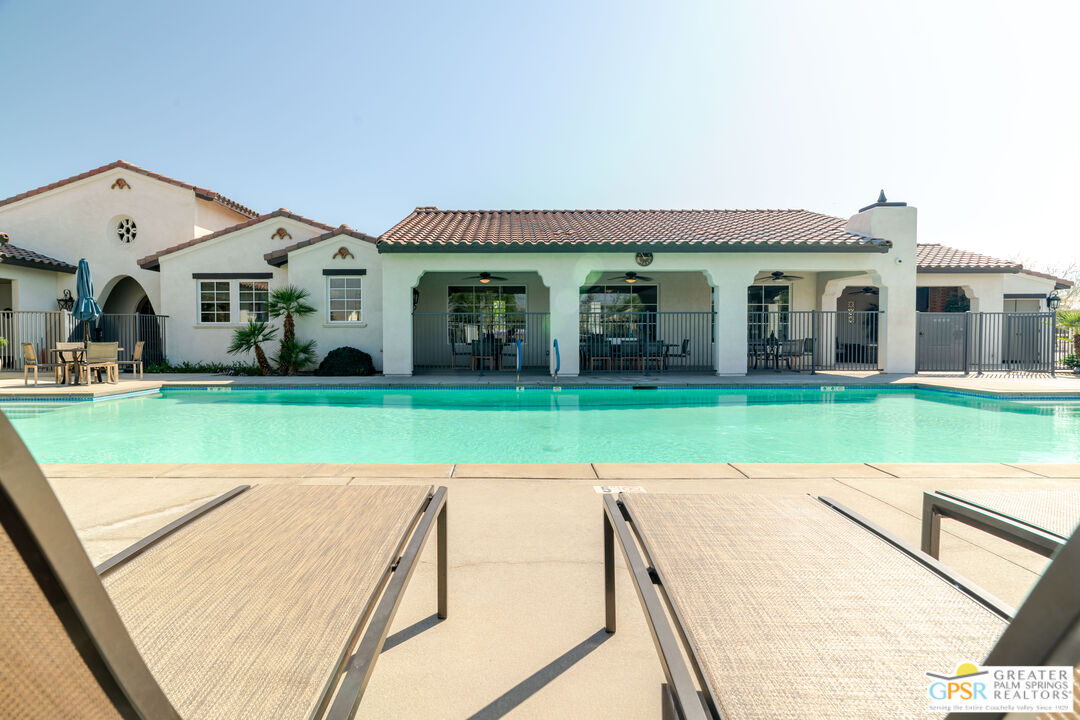 78924 Santa Rosa Way Palm Desert, CA 92211 - Photo 68 of 71 a view of a white house with a big yard and potted plants