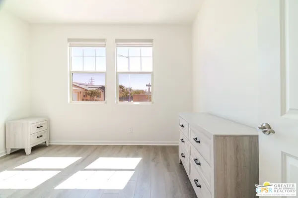 a living room with furniture a flat screen tv and a large window