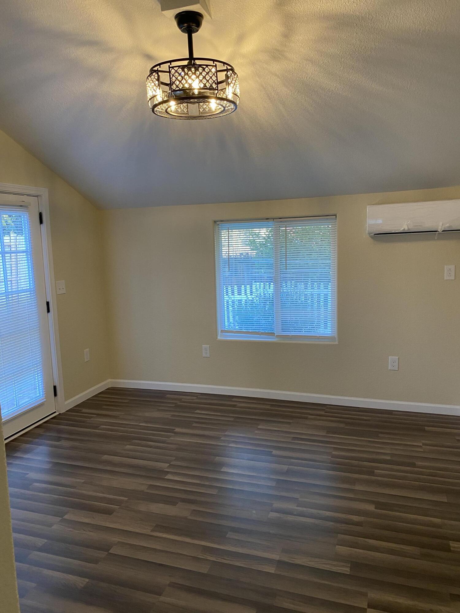 2180 El Reno Lane Redding, CA 96001 - Photo 23 of 39 a view of an empty room with wooden floor and a window