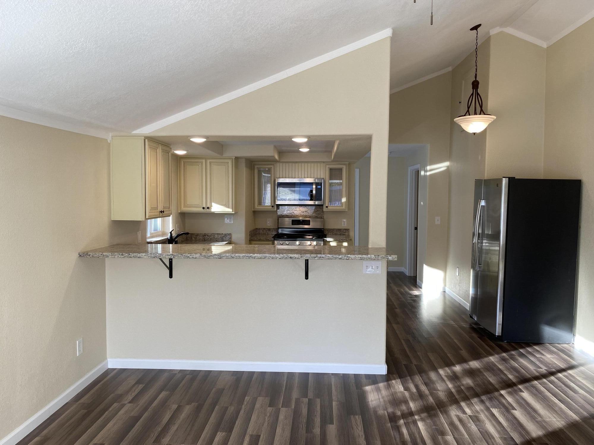 2180 El Reno Lane Redding, CA 96001 - Photo 8 of 39 a view of kitchen with refrigerator and wooden floor