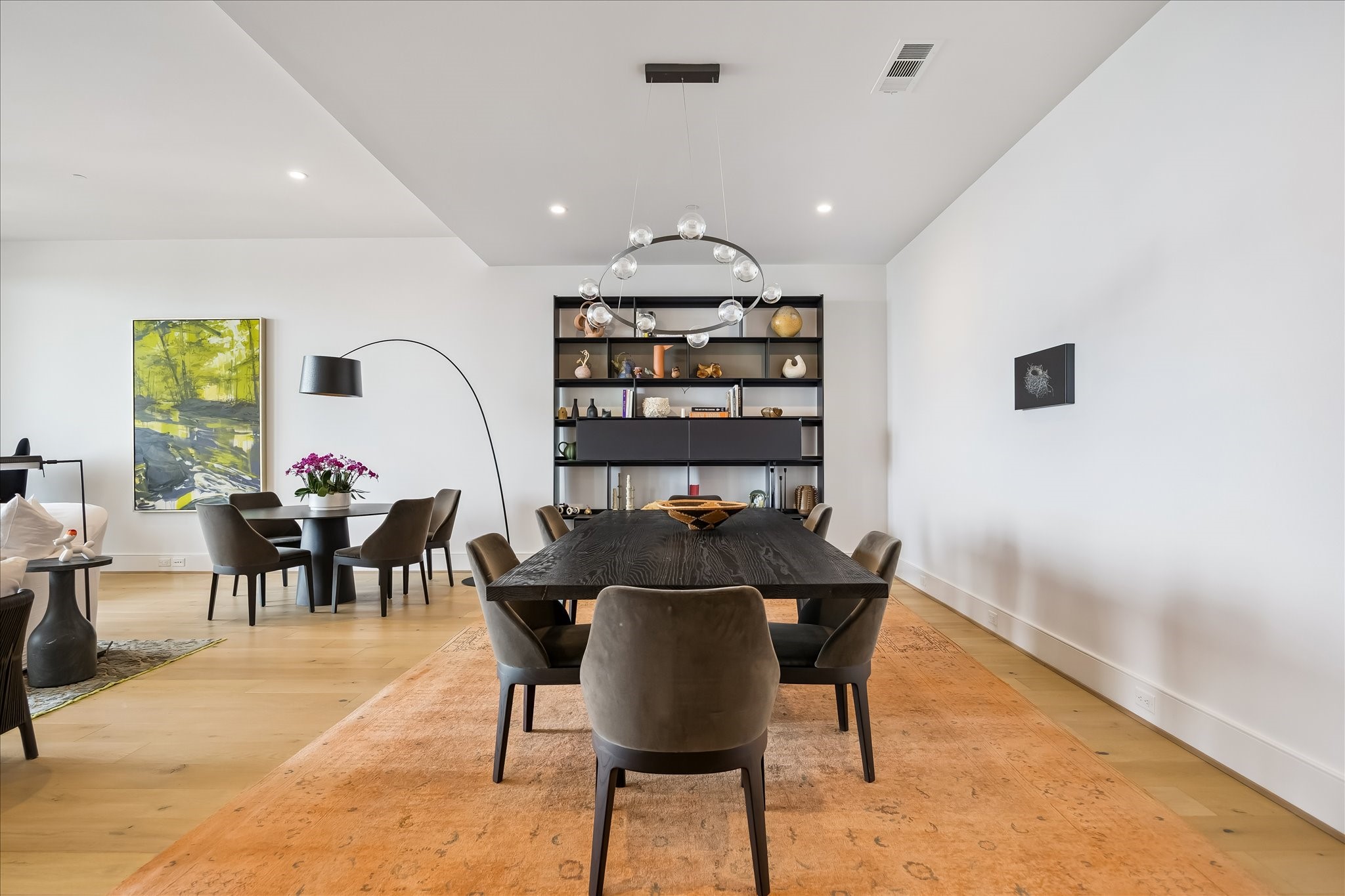 2325 Welch Street, Unit 704 Houston, TX 77019 - Photo 11 of 33 The formal dining room offers a refined setting with wide plank white oak floors and a statement chandelier. Its open flow enhances both everyday living and entertaining.