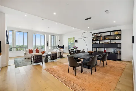 a living room with furniture a rug and a large window