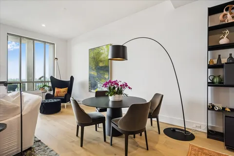 a dining room with furniture and floor to ceiling window