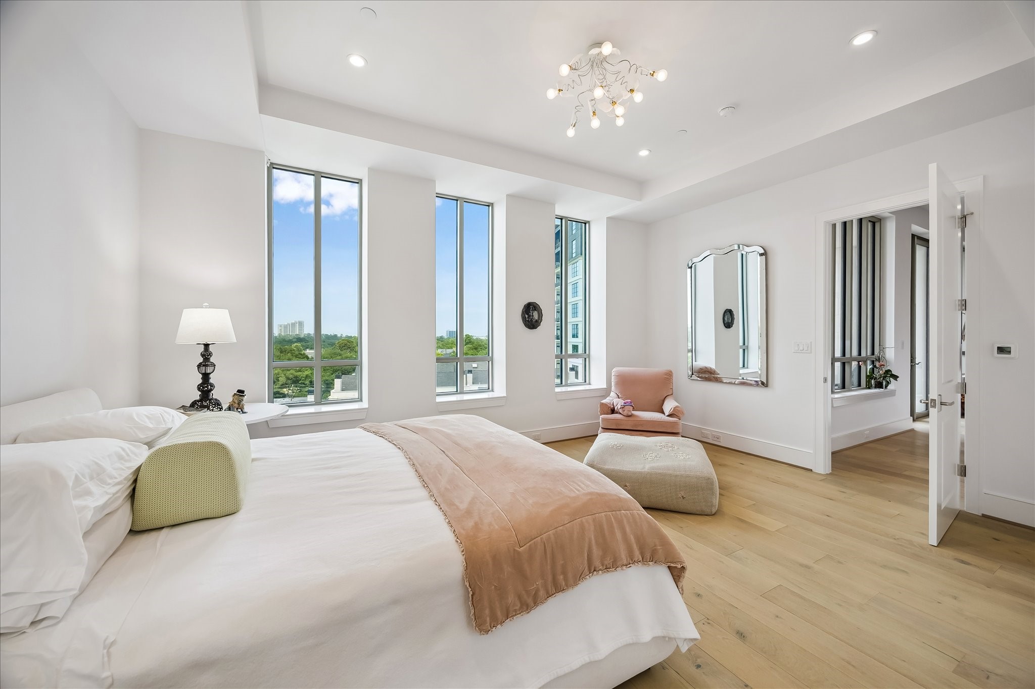 2325 Welch Street, Unit 704 Houston, TX 77019 - Photo 22 of 33 Designed for comfort and functionality, the primary bedroom features clean lines, warm wood floors, and multiple closet options. A peaceful retreat with a refined, modern feel.