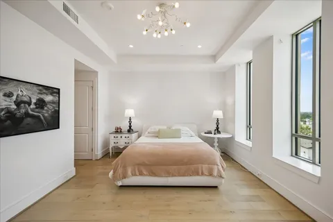 a bedroom with a large bed and a large window