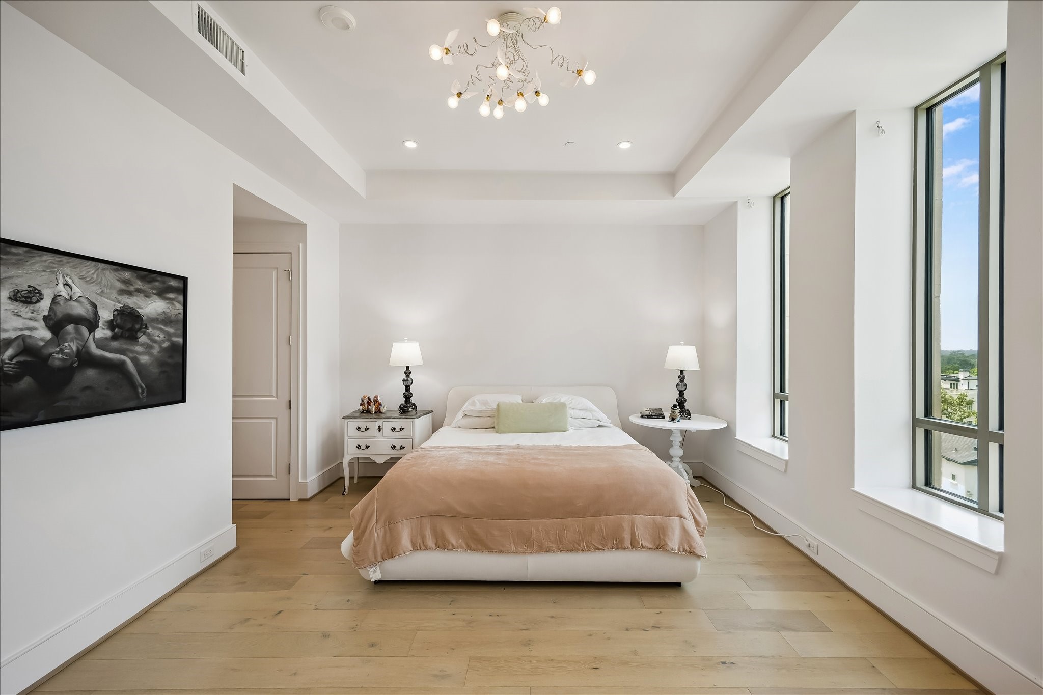 2325 Welch Street, Unit 704 Houston, TX 77019 - Photo 23 of 33 Spacious and inviting, the primary suite offers a calming palette, elevated ceilings, and abundant storage. Large windows bring in natural light while maintaining a sense of privacy.