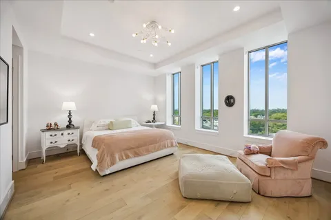 a spacious bedroom with a bed and window