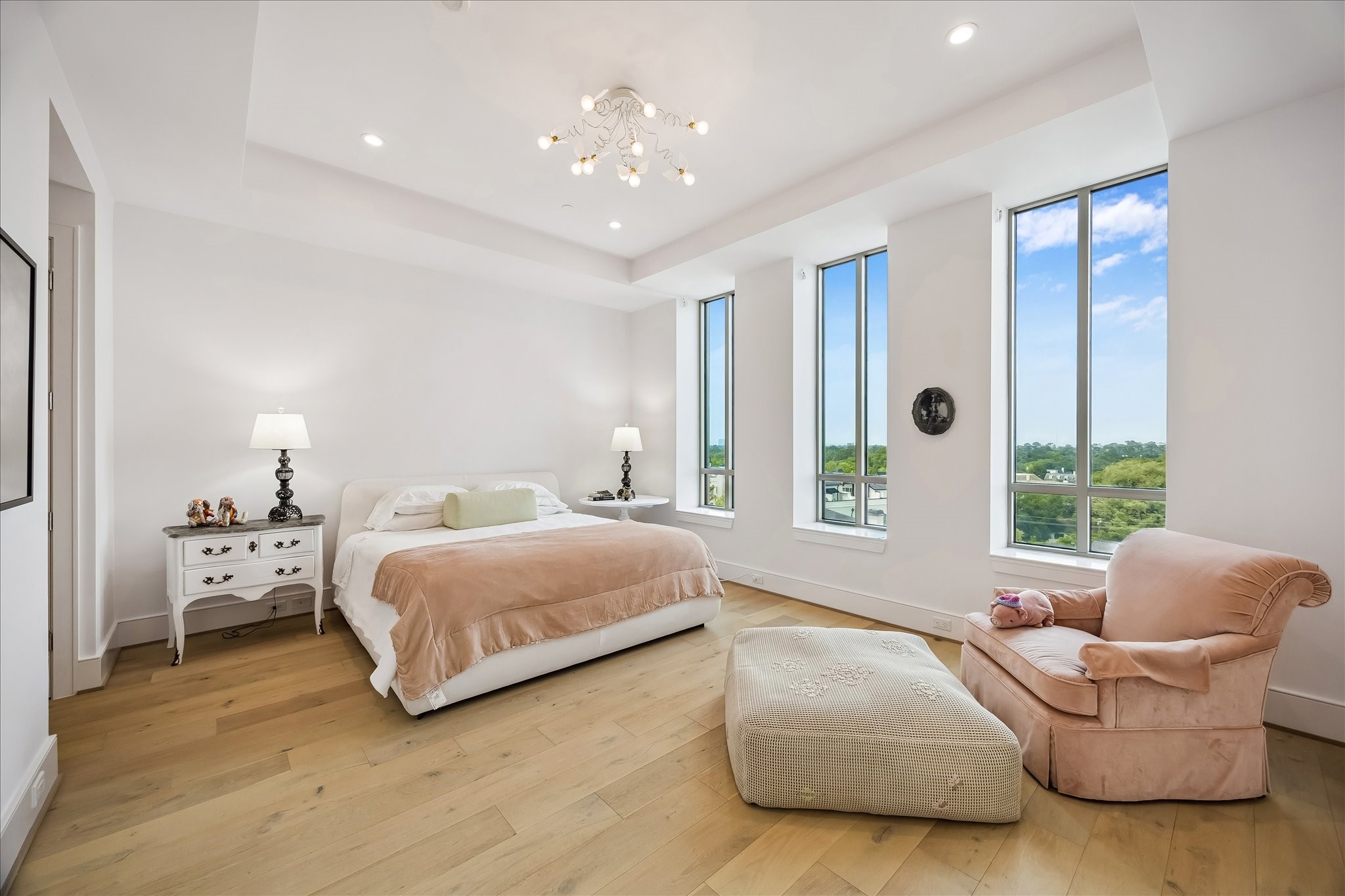 2325 Welch Street, Unit 704 Houston, TX 77019 - Photo 24 of 33 A serene primary retreat featuring 11’ ceilings, wide plank white oak floors, and soft natural light from north-facing windows. Thoughtfully designed with generous closet space, including a spacious walk-in closet.