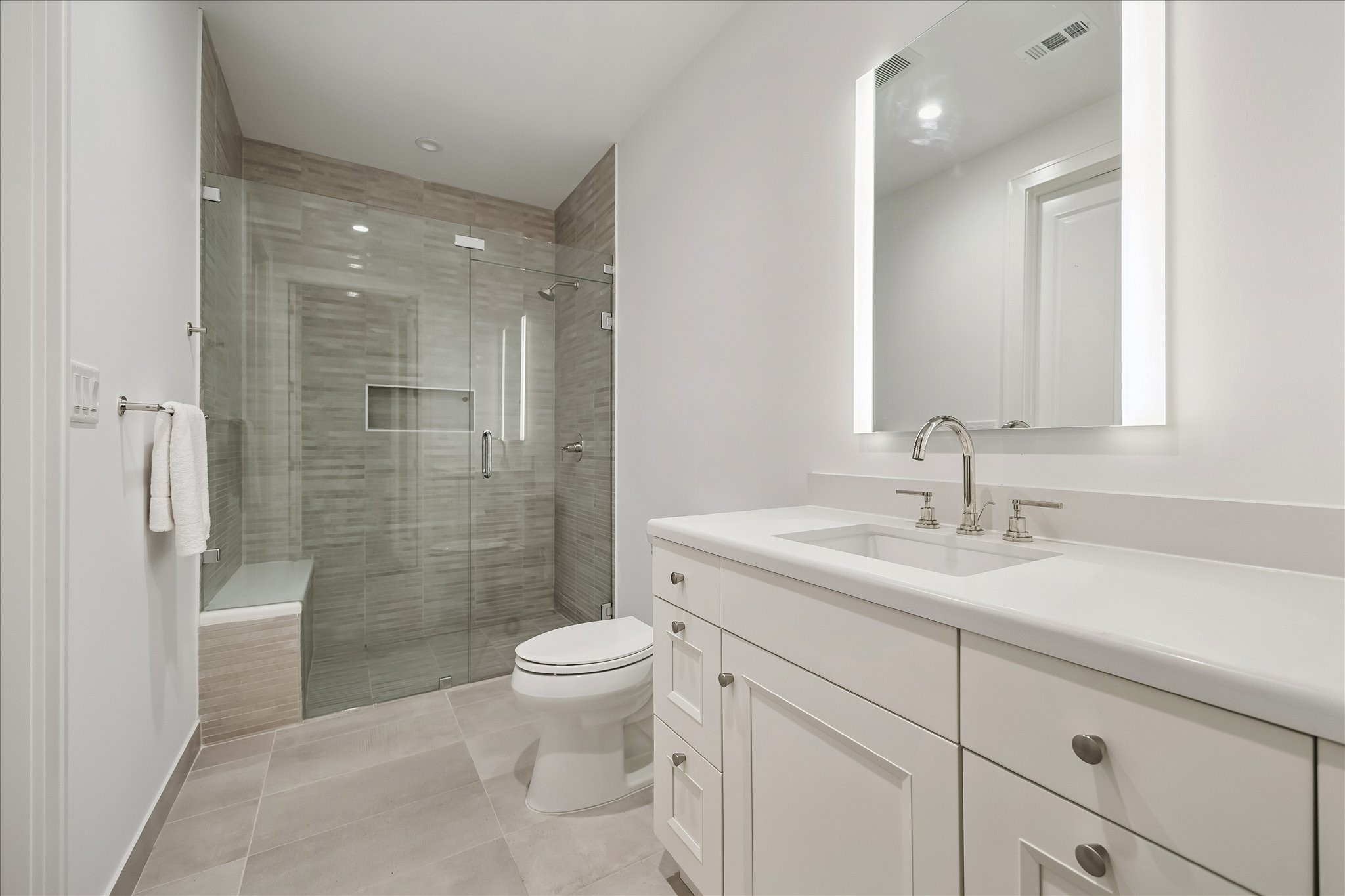2325 Welch Street, Unit 704 Houston, TX 77019 - Photo 29 of 33 Beautifully appointed with Walker Zanger porcelain tile and a sleek undermount sink, this bath blends style and function. A spacious walk-in shower with seamless glass doors and generous storage complete the space.