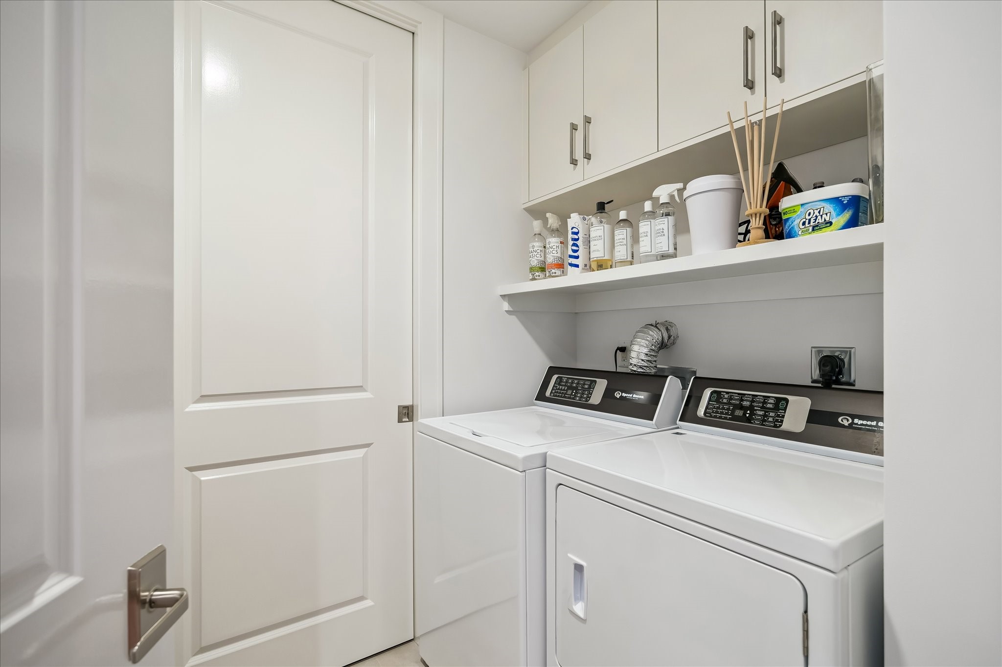 2325 Welch Street, Unit 704 Houston, TX 77019 - Photo 30 of 33 Designed for convenience, the utility room includes built-in cabinetry, tile floors, and a full-size Speed Queen washer and dryer. Easy access to the HVAC system adds everyday functionality.