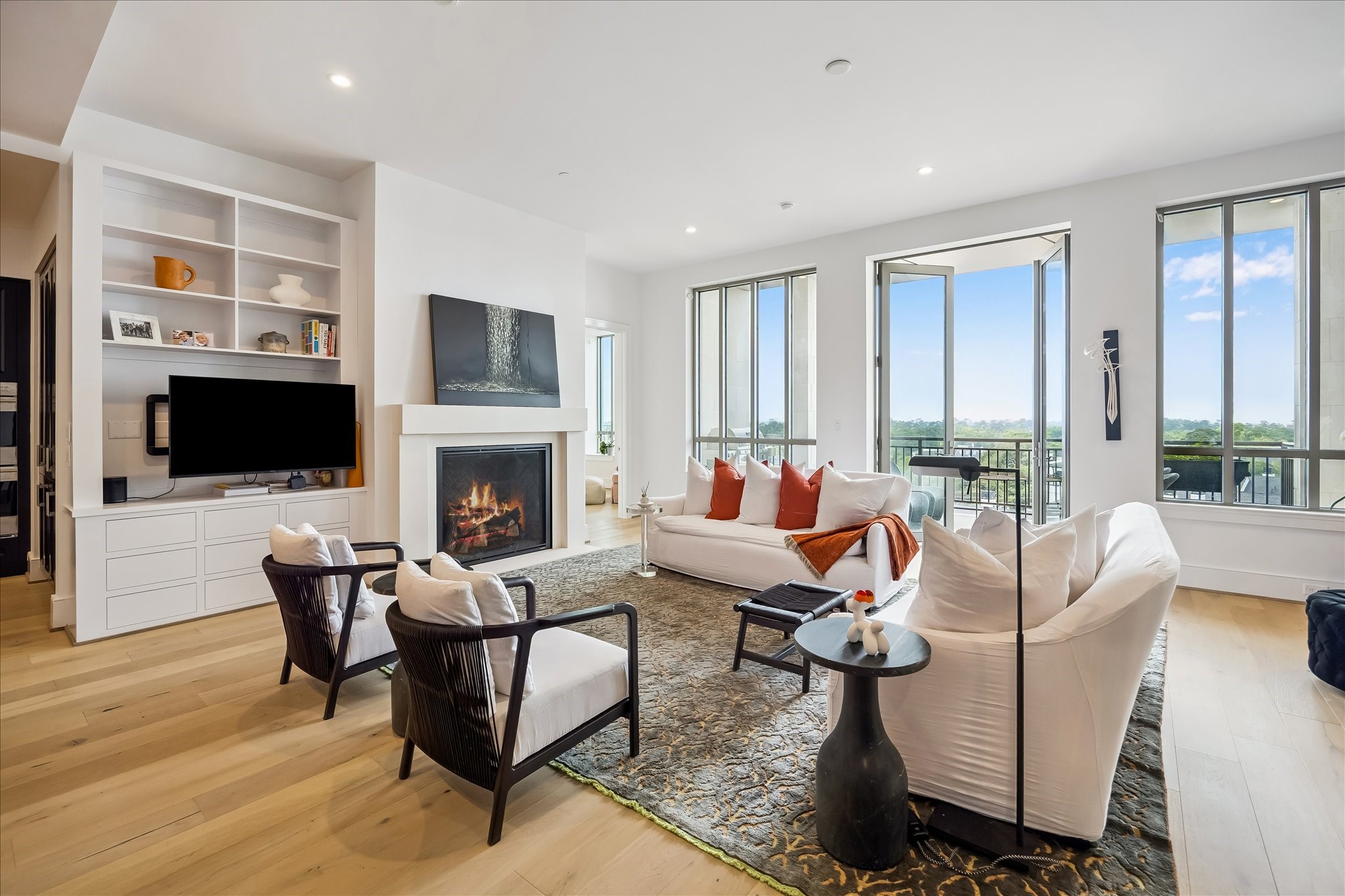 2325 Welch Street, Unit 704 Houston, TX 77019 - Photo 5 of 33 The heart of the home, this living space combines clean design with inviting details, including a fireplace focal point and direct access to the covered balcony.
