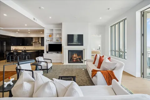 a living room with furniture fireplace and flat screen tv