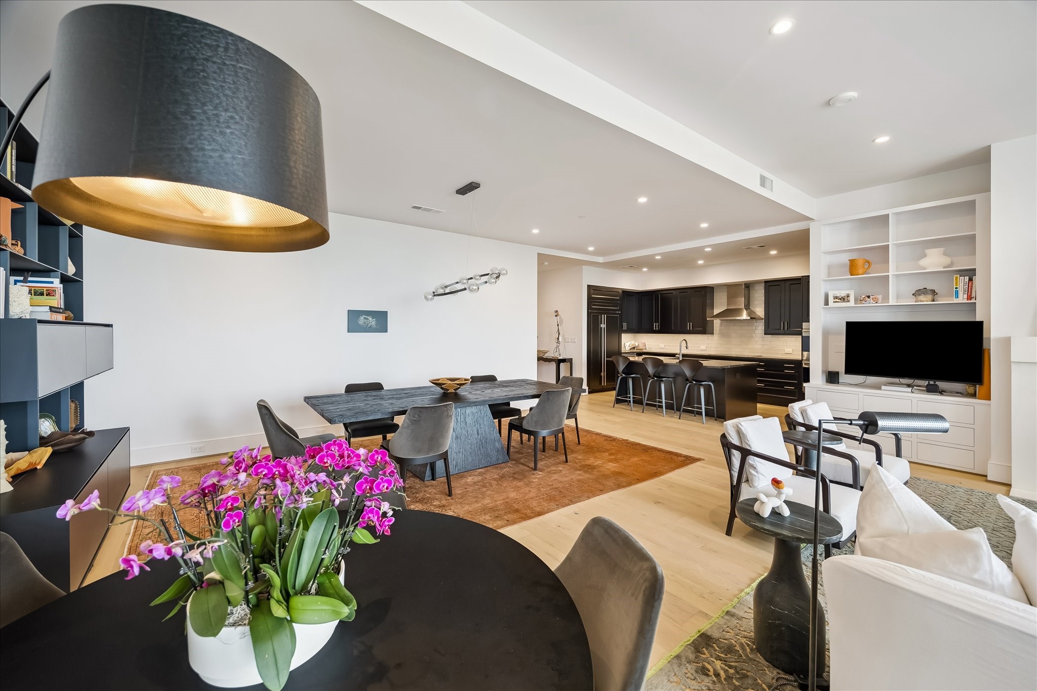 2325 Welch Street, Unit 704 Houston, TX 77019 - Photo 8 of 33 Seamlessly connected to the kitchen and dining areas, the living room offers effortless flow for everyday living. Clean lines, natural light, and direct balcony access enhance the overall experience.