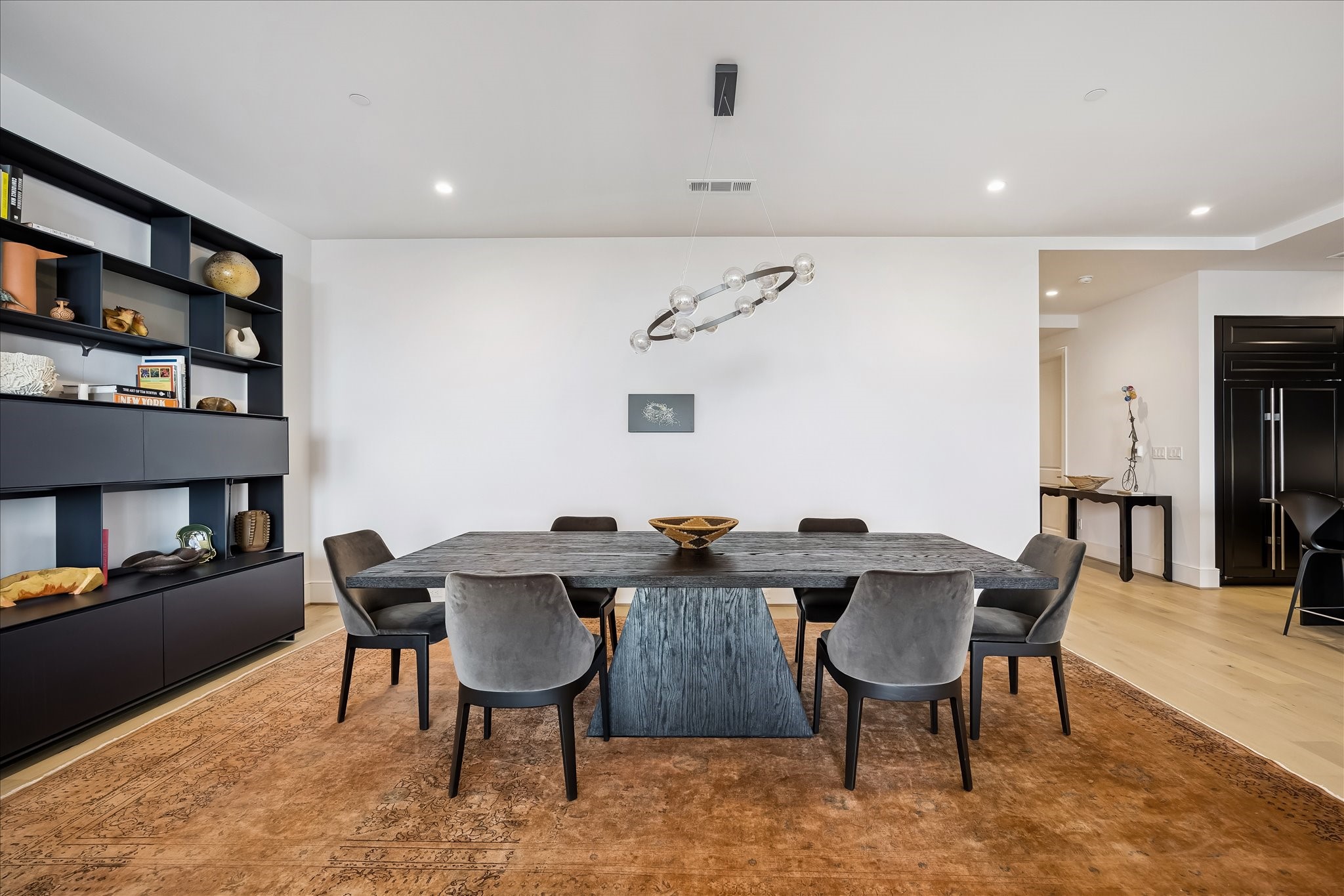 2325 Welch Street, Unit 704 Houston, TX 77019 - Photo 10 of 33 An elegant dining space with soaring 11’ ceilings, designer lighting, and an open connection to the kitchen and living room. Perfectly suited for both intimate dinners and larger gatherings.