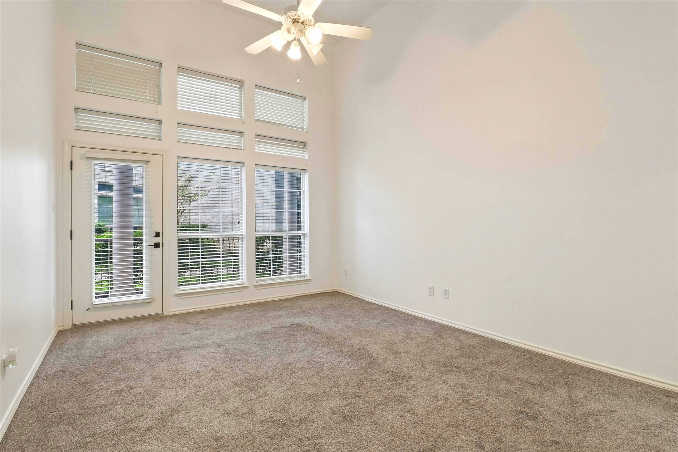 2918 Ranch Road 620, Unit 265 Austin, TX 78734 - Photo 17 of 40 Naturally illuminated living space featuring high ceilings and direct outdoor access.