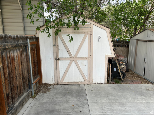 7659 State Street Midvale, UT 84047 - Photo 32 of 33 View of shed with a fenced backyard