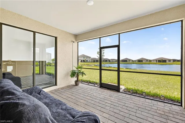 a bedroom with a bed and large windows