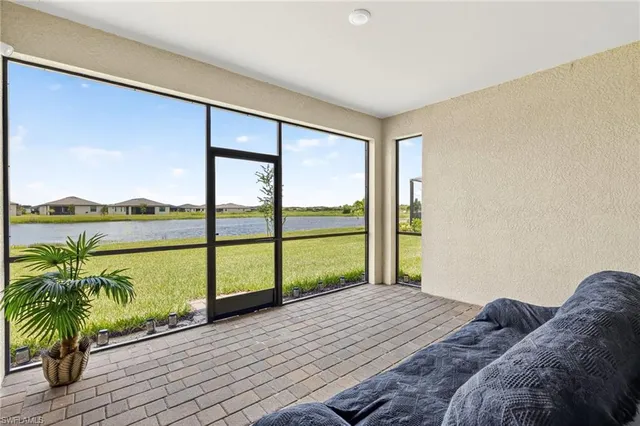 a bedroom with a bed and glass door