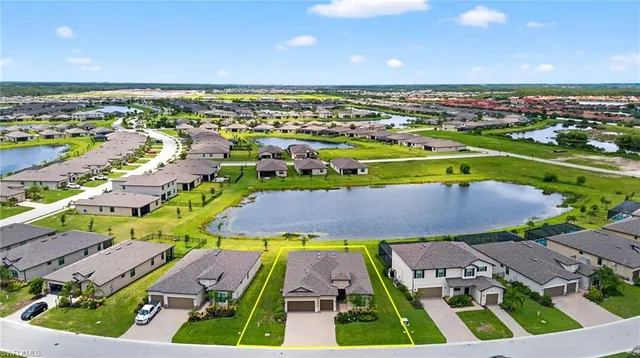 an aerial view of a pool yard and mountain view in back