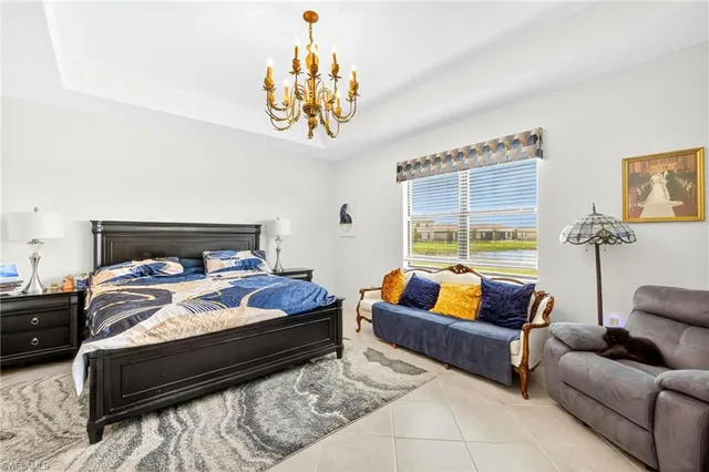 a bedroom with furniture and a large window