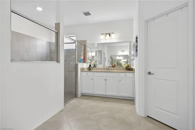 a bathroom with a shower sink and mirror