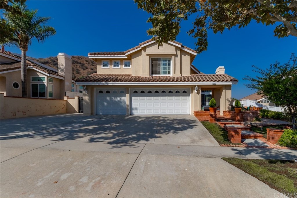 1592 Dominguez Ranch Road Corona, CA 92882 - Photo 1 of 1 a front view of a house with garden and parking
