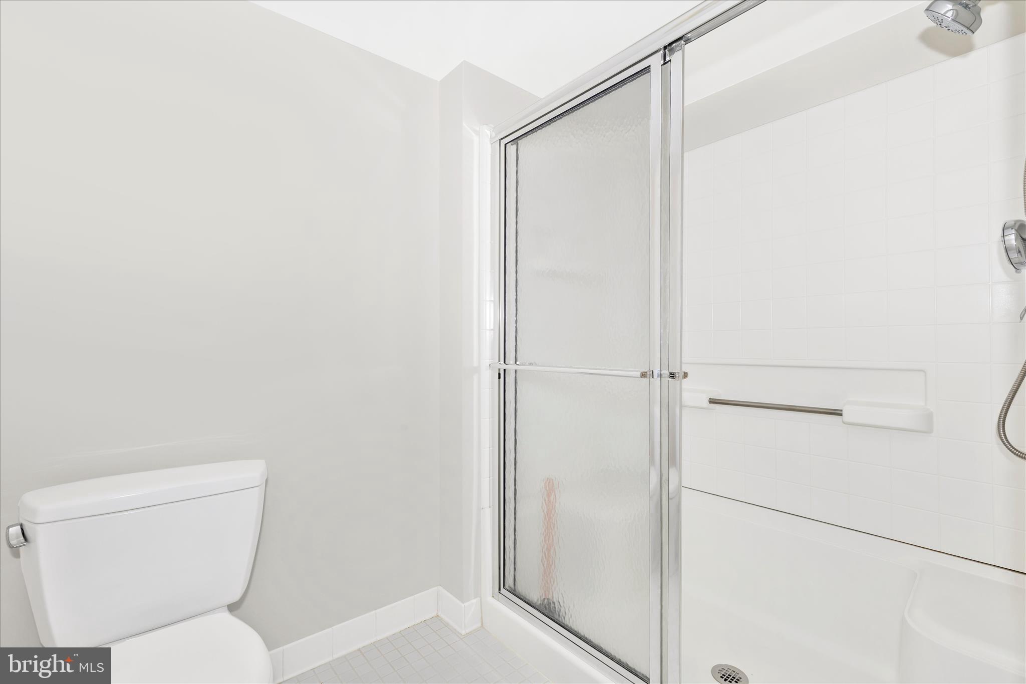 14809 Pennfield Circle, Unit 309 Silver Spring, MD 20906 - Photo 21 of 64 a bathroom with a toilet and a shower