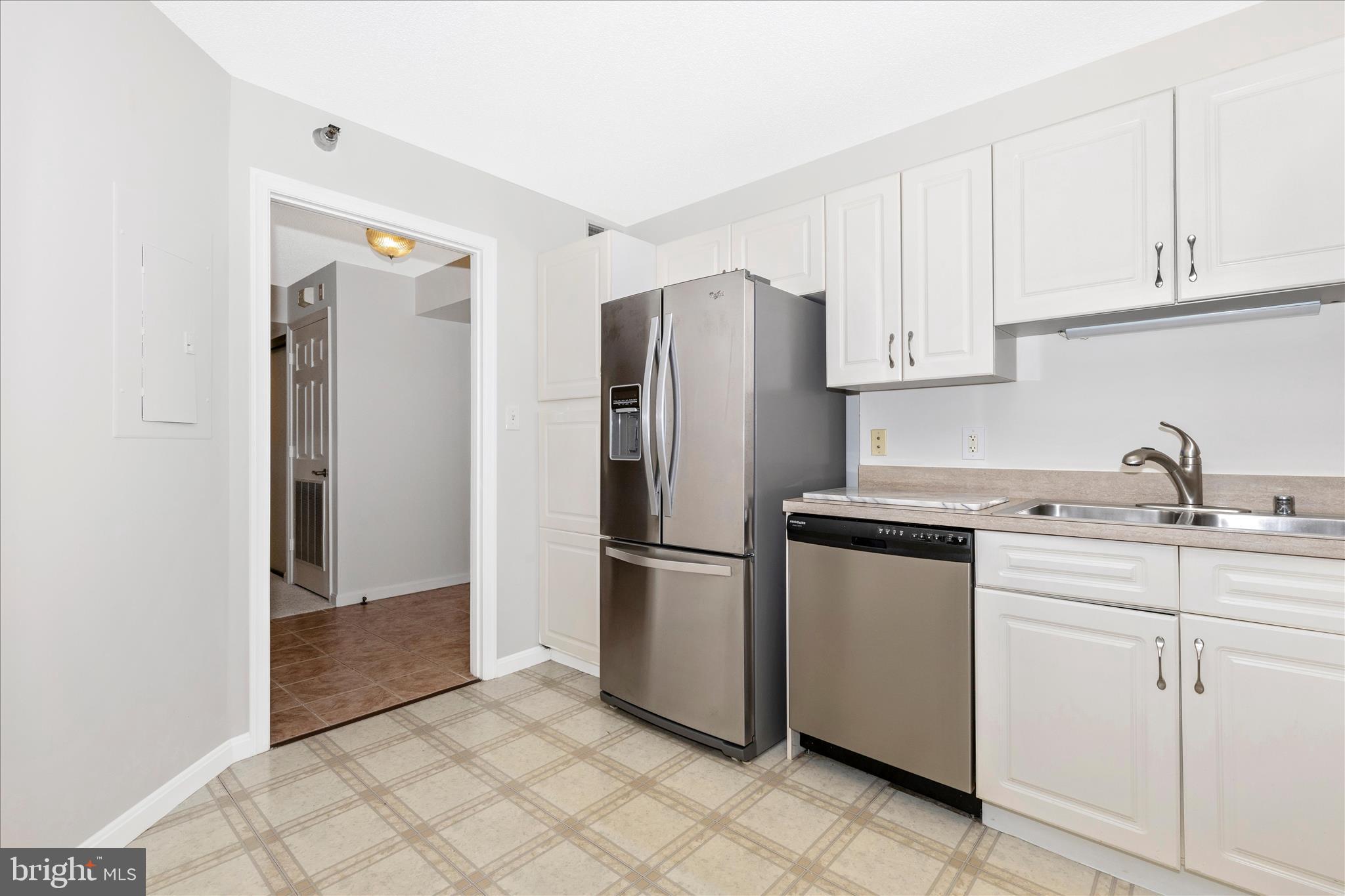 14809 Pennfield Circle, Unit 309 Silver Spring, MD 20906 - Photo 4 of 64 a kitchen with stainless steel appliances granite countertop a refrigerator and a sink