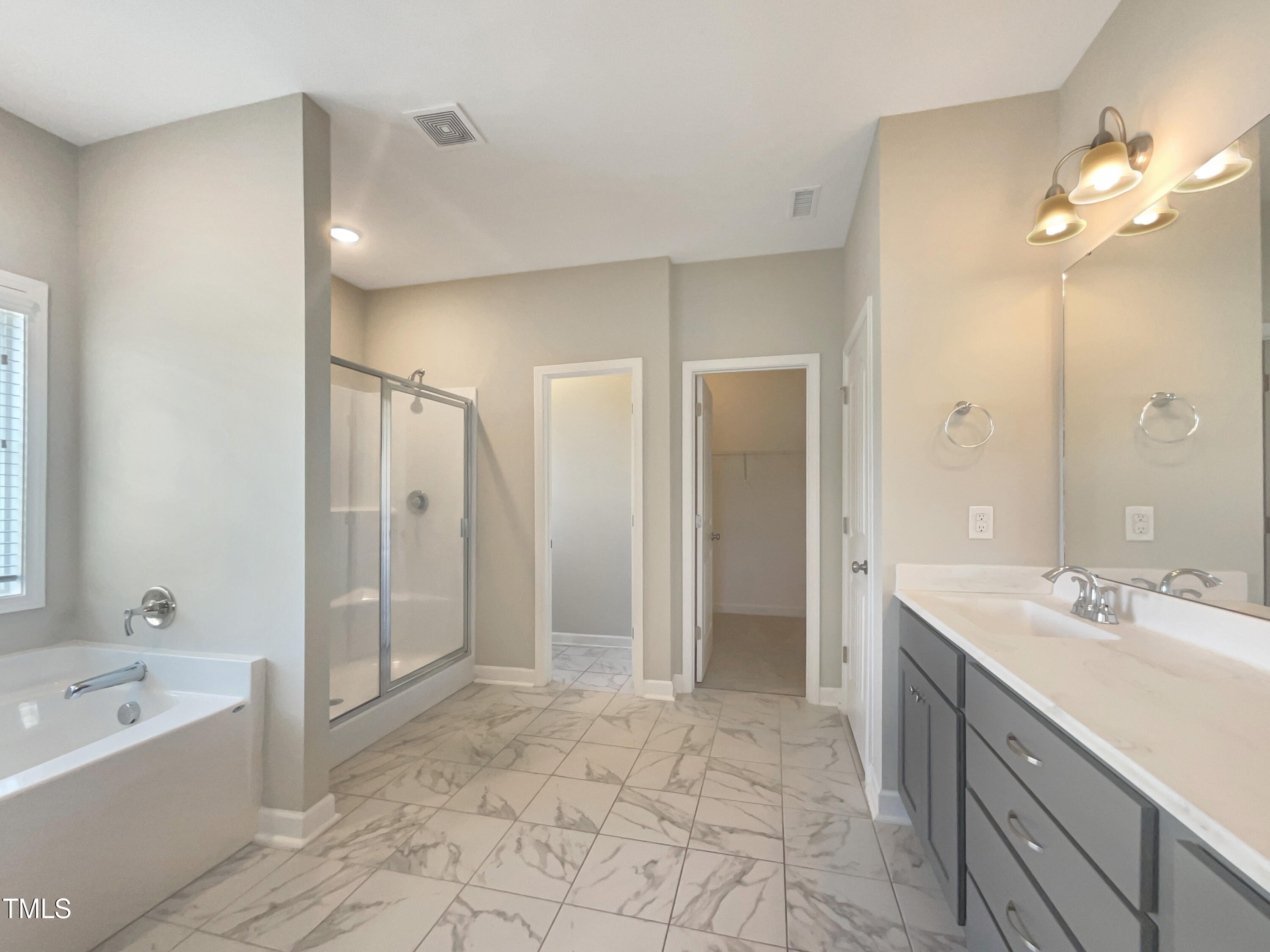 197 Steep Rock Drive Willow Spring, NC 27592 - Photo 12 of 20 a spacious bathroom with a tub sink shower and mirror