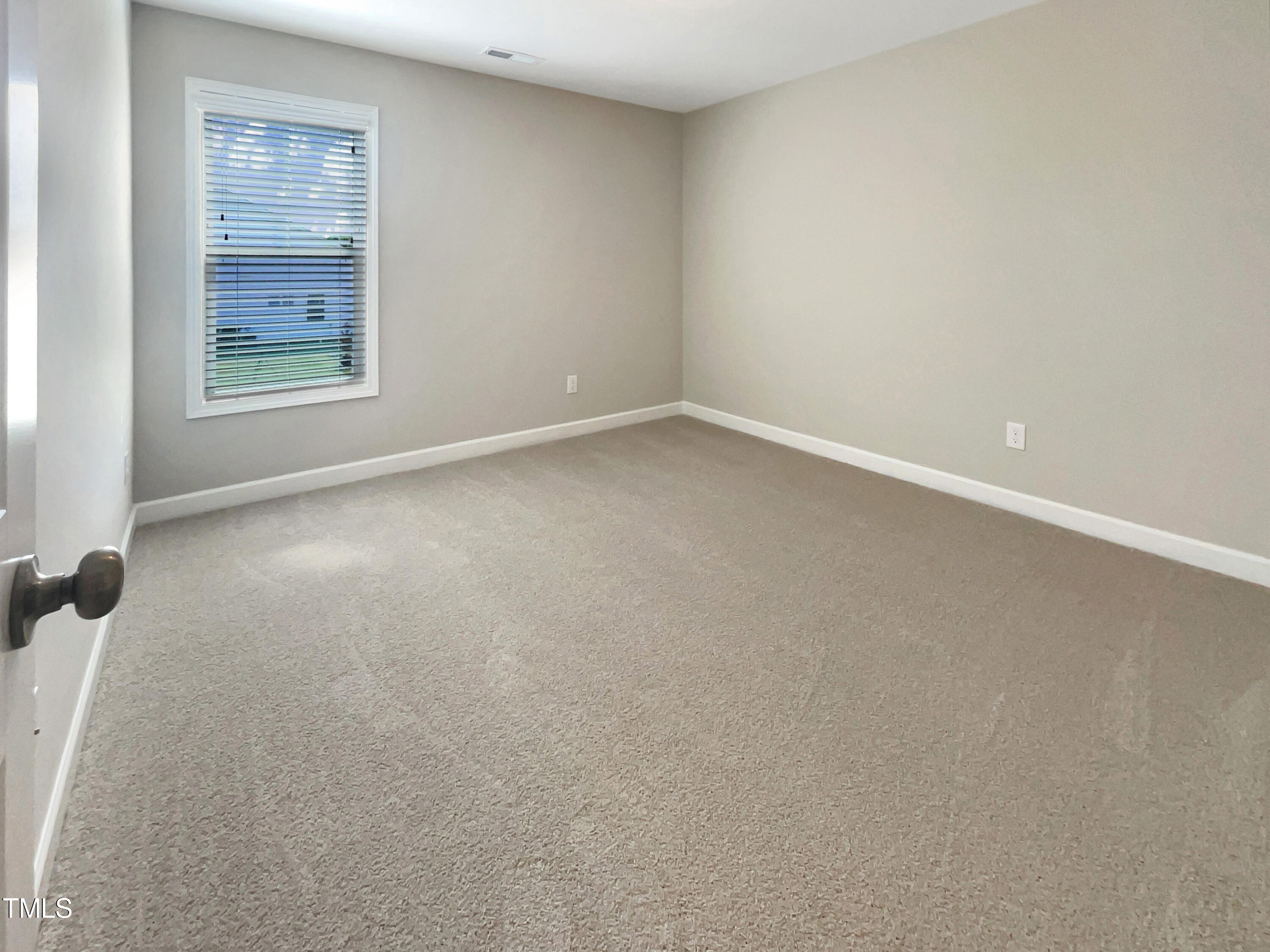 197 Steep Rock Drive Willow Spring, NC 27592 - Photo 14 of 20 an empty room with windows