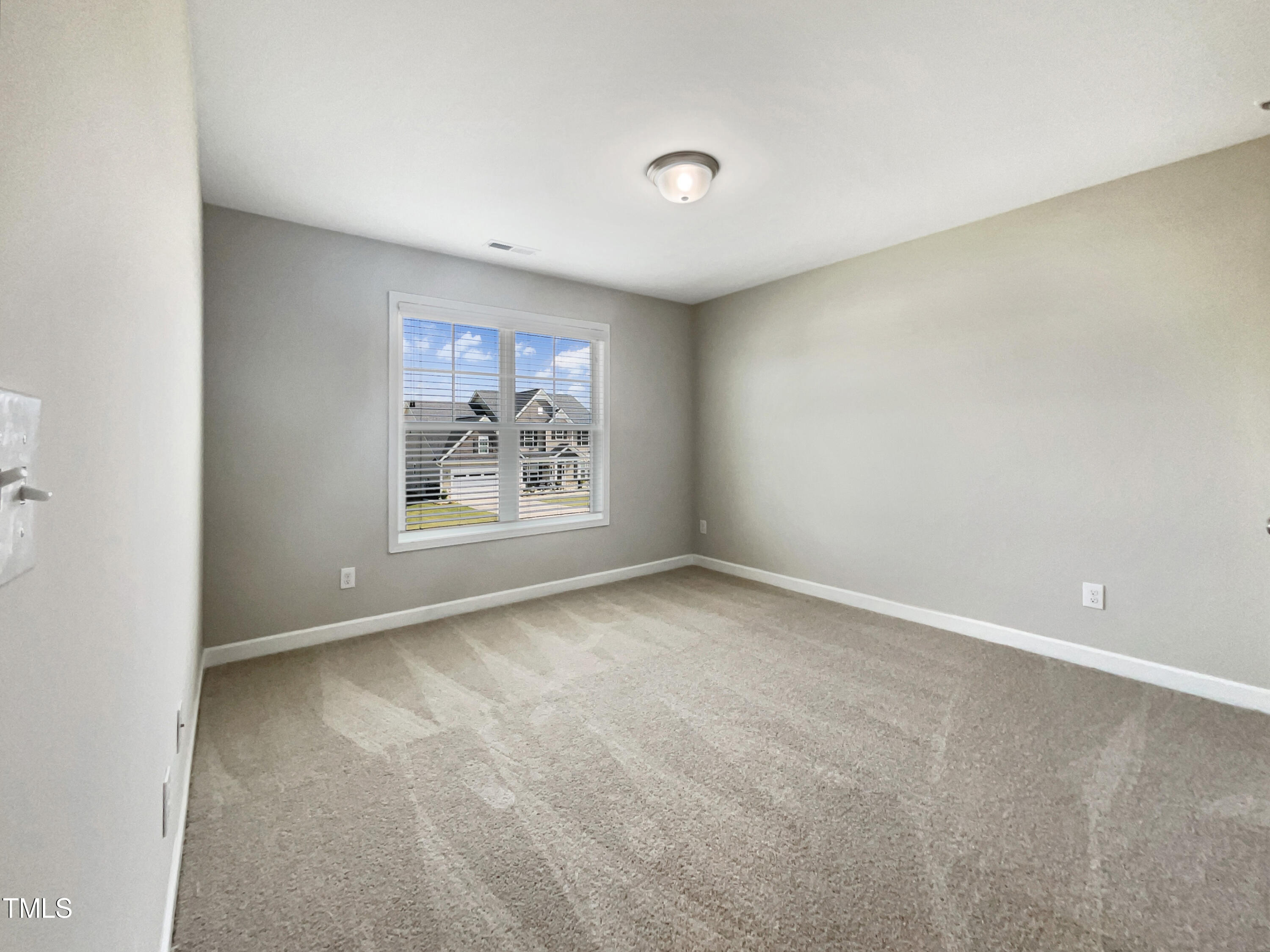 197 Steep Rock Drive Willow Spring, NC 27592 - Photo 15 of 20 a view of an empty room with a window
