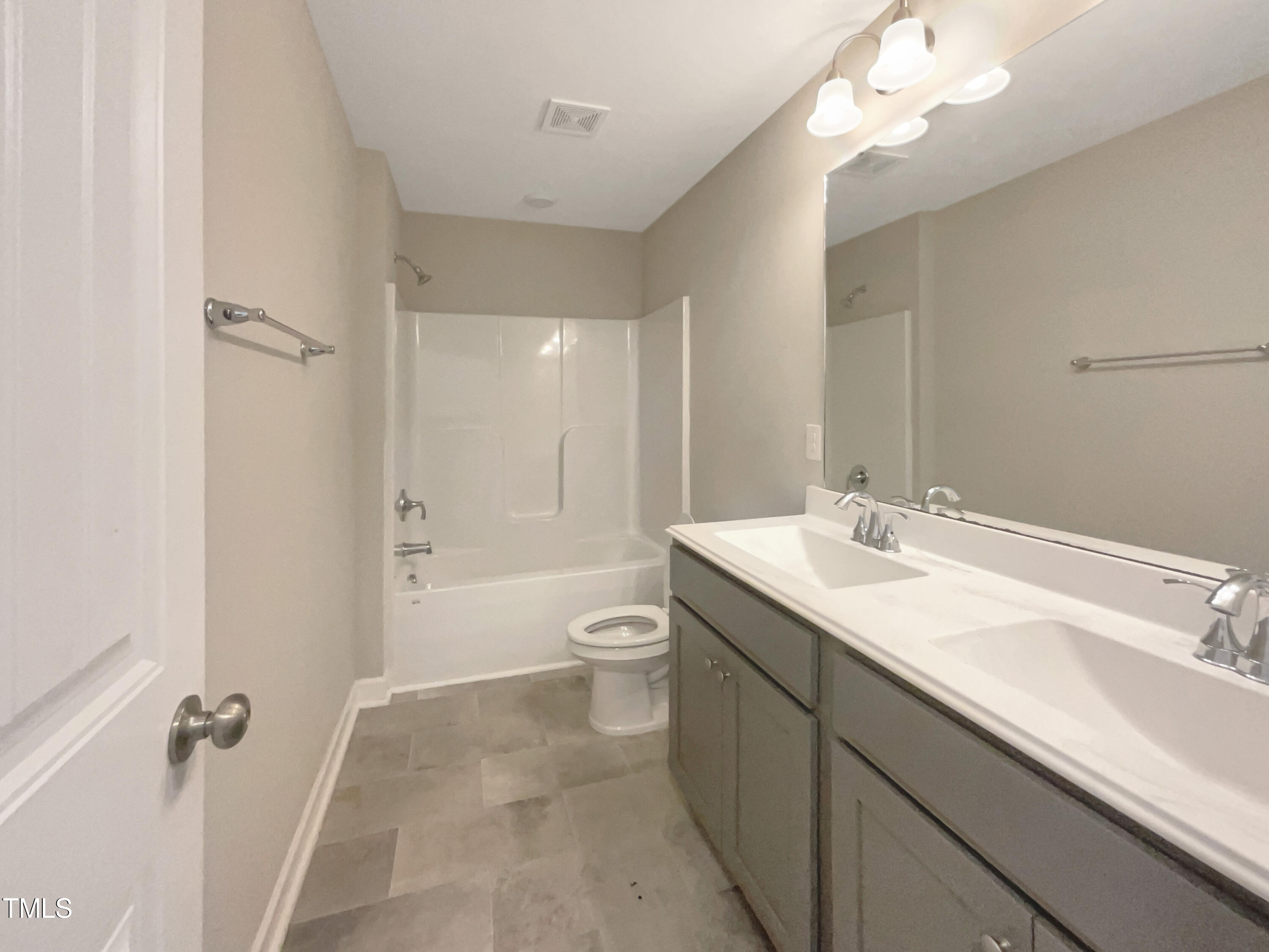 197 Steep Rock Drive Willow Spring, NC 27592 - Photo 16 of 20 a bathroom with a sink a toilet a shower and a mirror