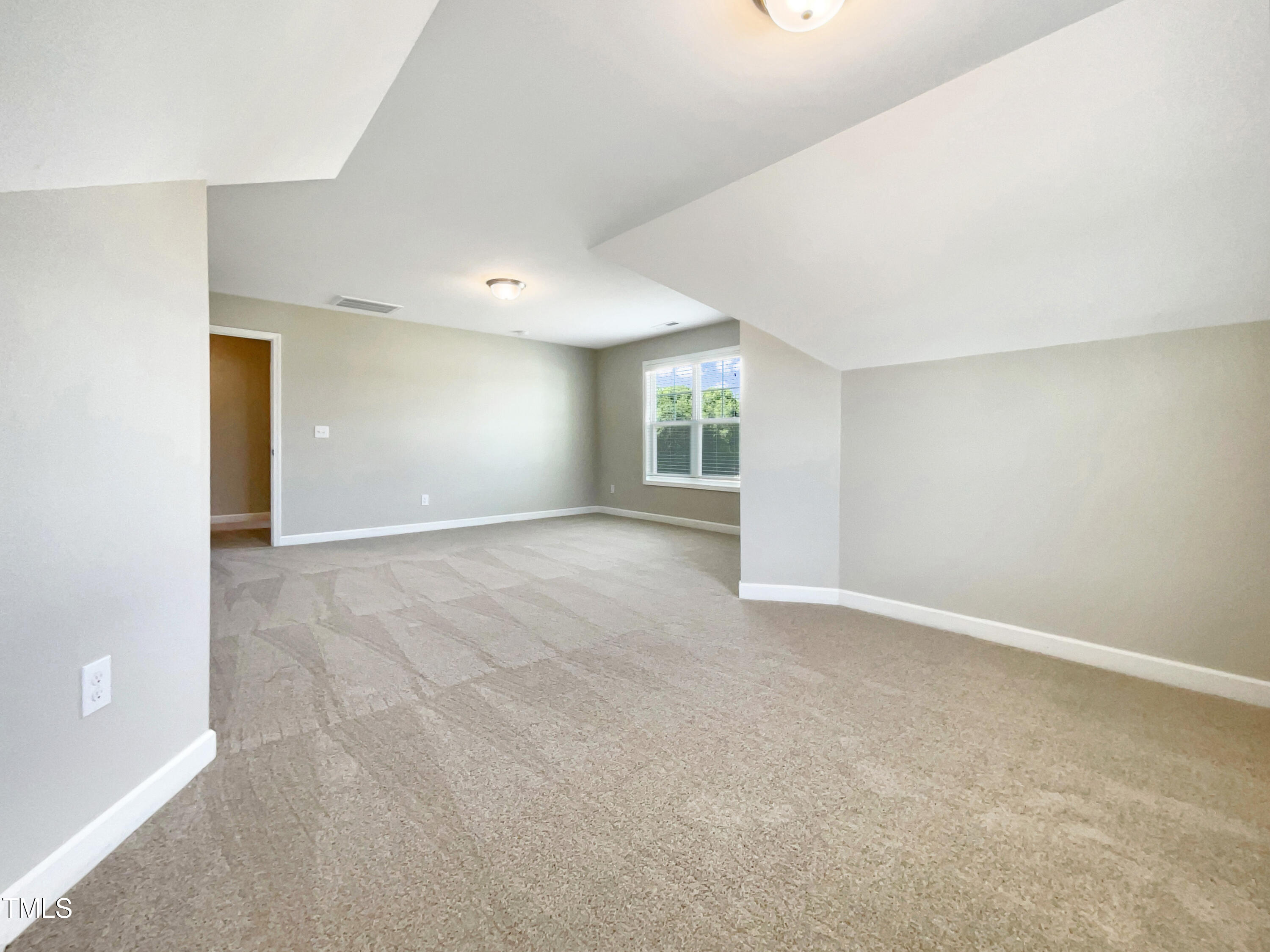 197 Steep Rock Drive Willow Spring, NC 27592 - Photo 18 of 20 a view of an empty room with a window