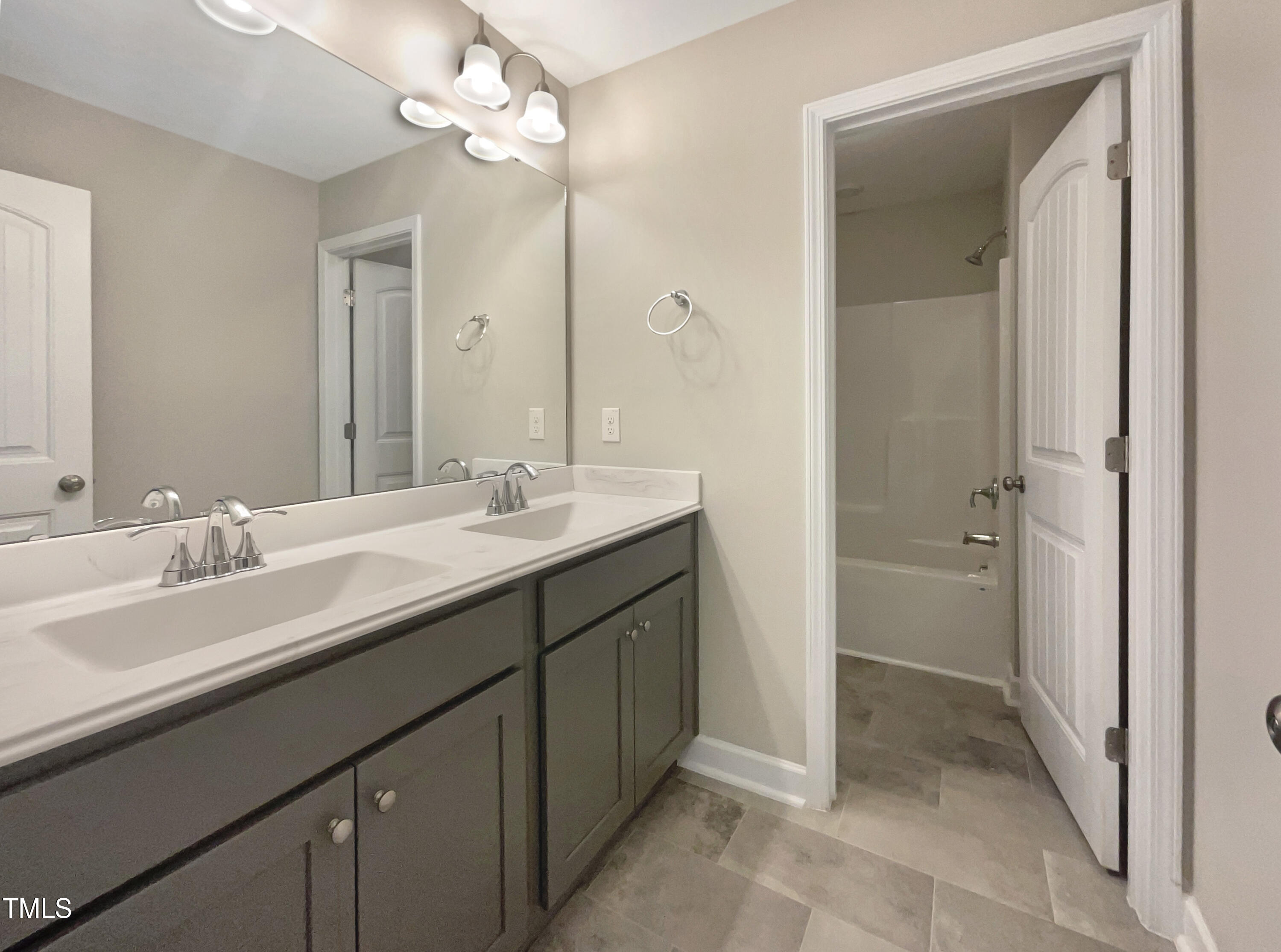 197 Steep Rock Drive Willow Spring, NC 27592 - Photo 8 of 20 a bathroom with a double vanity sink a mirror and a shower