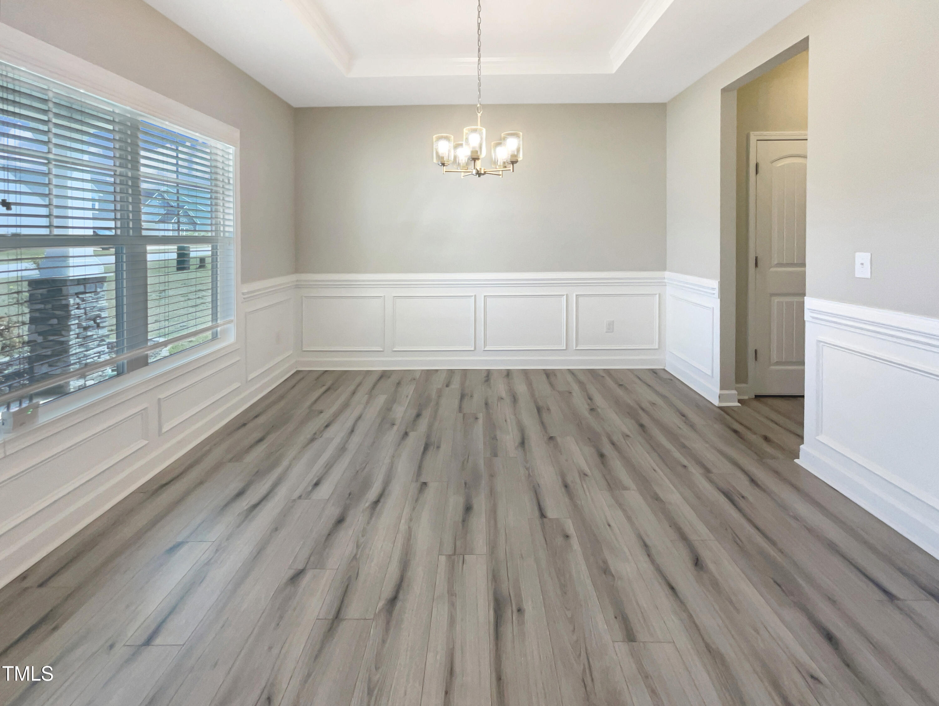 197 Steep Rock Drive Willow Spring, NC 27592 - Photo 10 of 20 a view of wooden floor and windows in an empty room