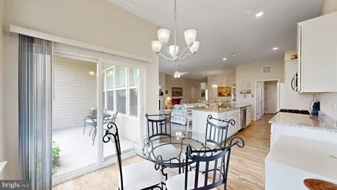 a view of a dining room and livingroom furniture and windows