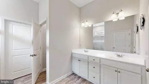 a bathroom with a double vanity sink mirror and double