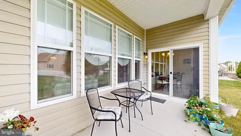 a view of a room with chairs and table in a patio