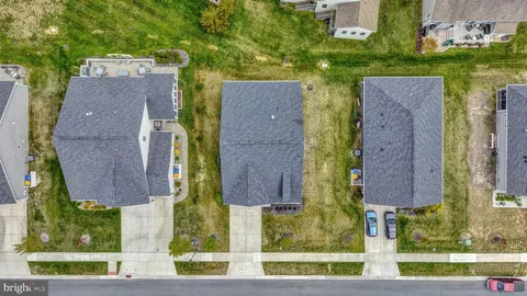 an aerial view of houses with yard