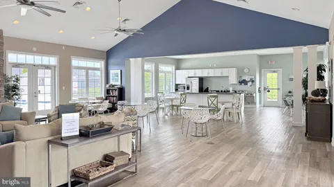 a living room with lots of furniture and a large window