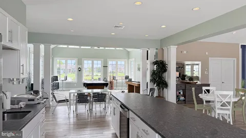 a living room with furniture a fireplace and a large window