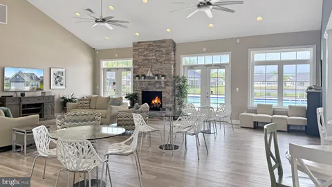 a living room with furniture a chandelier and a dining table