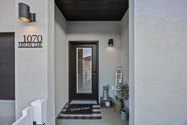 a view of a hallway with wooden floor and a living room