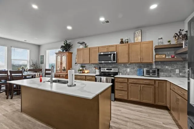 a kitchen with counter top space a sink cabinets and appliances