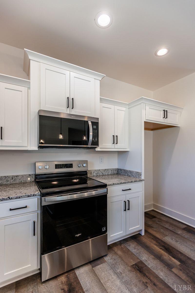 9740 Oakville Road Gladstone, VA 24553 - Photo 31 of 75 a kitchen with stainless steel appliances white cabinets and a stove top oven