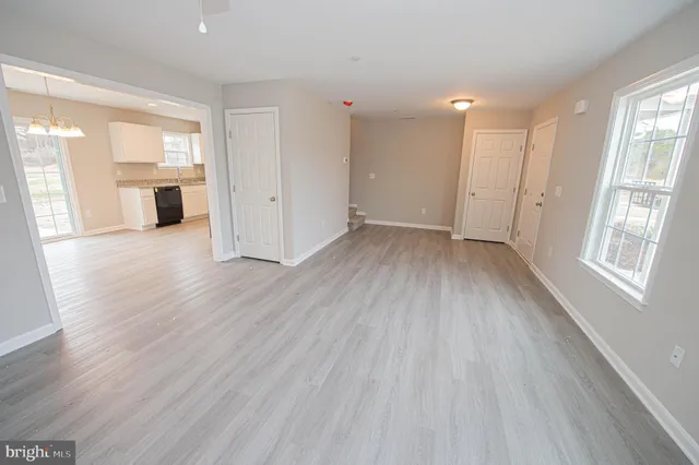 a kitchen with granite countertop a refrigerator stove and sink