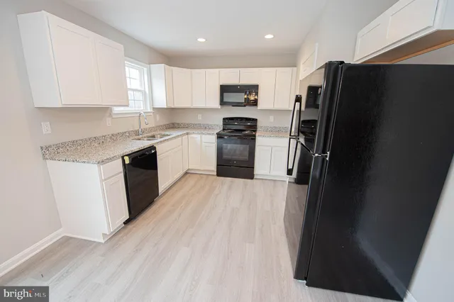 a view of walk in closet with wooden floor and staircase