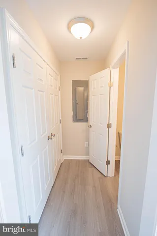 a view of a room with wooden floor and entryway