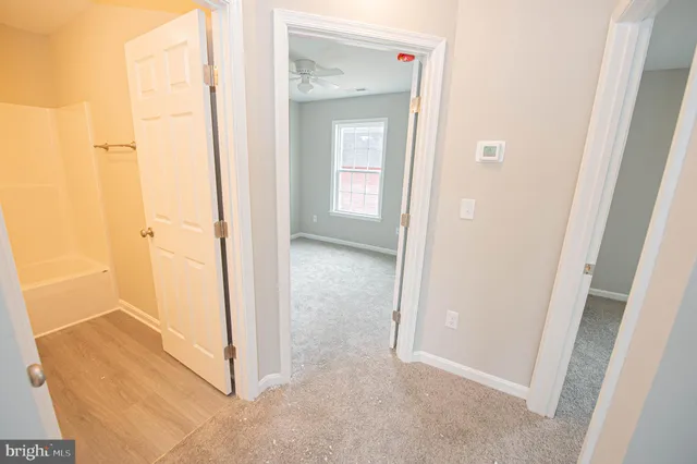 a spacious bathroom with a sink a mirror and a toilet